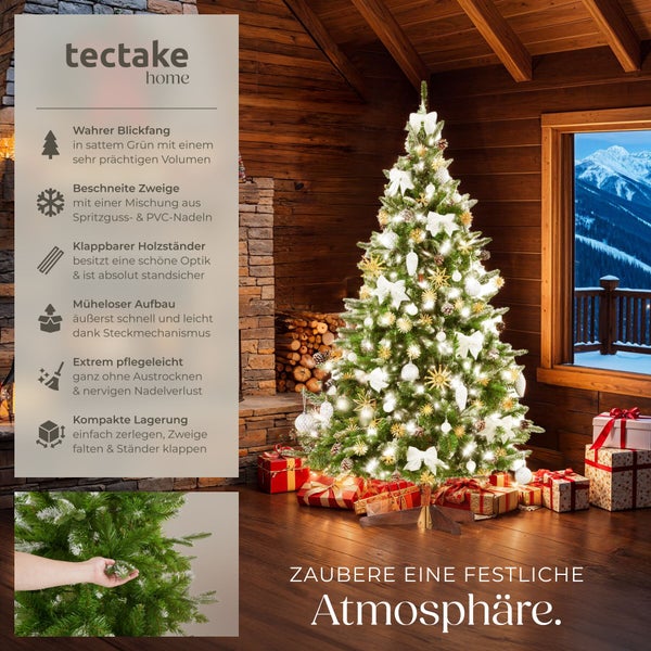 Tectake Home kuenstlicher Weihnachtsbaum mit LED Beleuchtung, geschmueckt in einem rustikalen Wohnraum mit Ausblick auf verschneite Berge.
