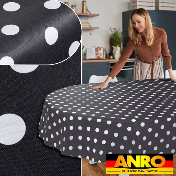 Abwaschbare Tischdecke in Anthrazit mit weißen Punkten auf einem runden Tisch in einer hellen, organisierten Küche, Detailansicht und ANRO Logo.