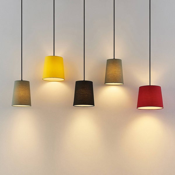 Fünf verschiedene Pendelleuchten mit Textilschirm hängen von der Decke