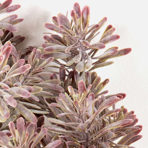 Künstliche Sukkulente mit rotbraunen fleischigen Blättern und braunem Stiel.