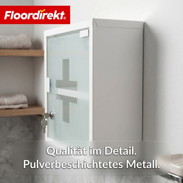 Floordirekt Logo. Medikamentenschrank aus pulverbeschichtetem Metall mit abschließbarer Glastür und Erste-Hilfe-Symbol.