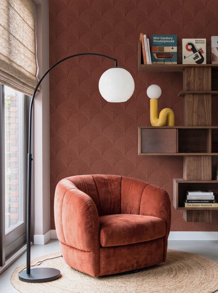 Modernes Wohnzimmer mit strukturierter Bogentapete, gepolstertem Sessel, Holzwandregal, Bogenstehleuchte und rundem Jutesteppich.