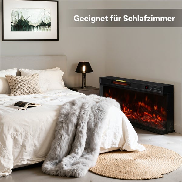 Schlafzimmer mit Bett, Nachttischlampe und elektrischem Kamin