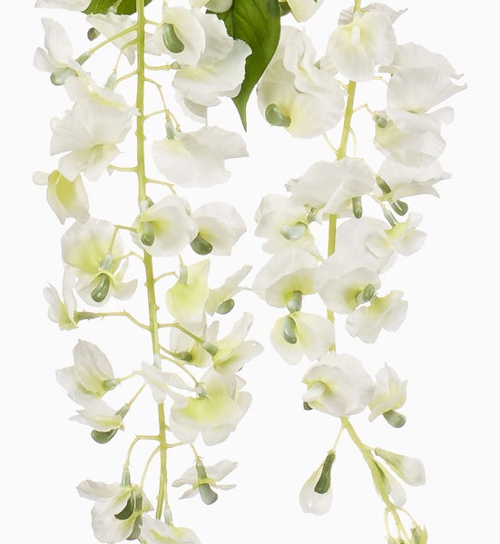 Künstlicher Zweig mit weißen Blüten und grünen Blättern.