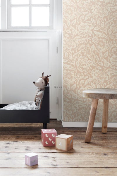 Vliestapete mit floralem Muster in einem hellen Kinderzimmer mit Holzboden, kleinem Bett und Hocker. ESTAhome Logo.
