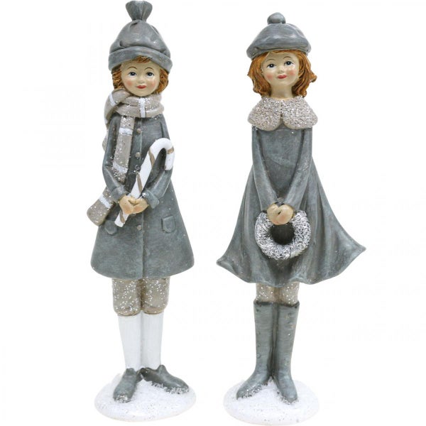 Zwei dekorative Figuren von Mädchen mit Winterkleidung
