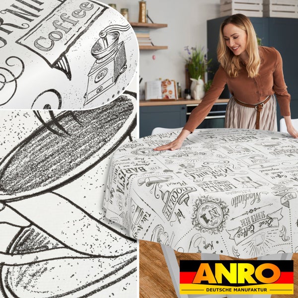 Eine Frau breitet eine runde, abwaschbare Wachstuch-Tischdecke mit Kaffee-Motiven und Barista-Design in einer hellen Küche aus. ANRO Logo.