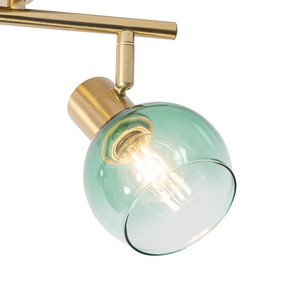 Detailaufnahme einer grünen Glaslampe mit goldfarbener Halterung für die Deckenmontage