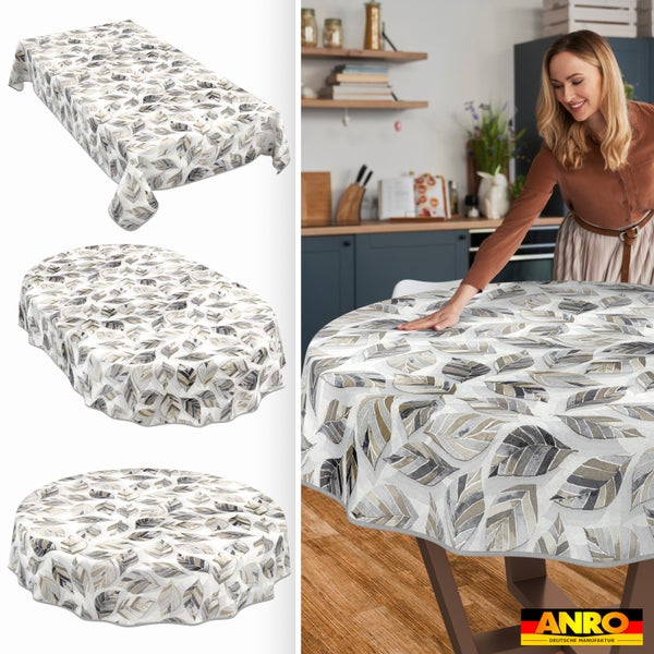 Tischdecke mit Blattmuster in rechteckiger, ovaler und runder Form, eine Frau breitet die Decke auf einem Küchentisch aus. ANRO Logo.