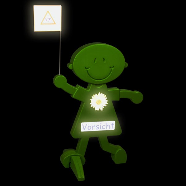 Grüne Sicherheitsfigur mit Warnschild Fussgängerüberweg und dem Wort Vorsicht