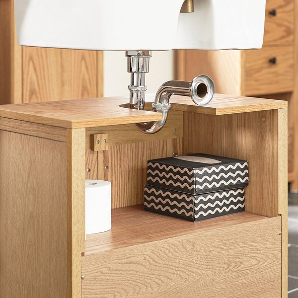 Waschtischunterschrank mit Siphon, Toilettenpapier und einer schwarzen Schachtel