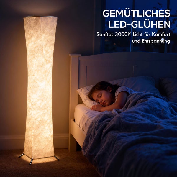 Szene mit einer schlafenden Person neben einer LED-Stehlampe im Zimmer.