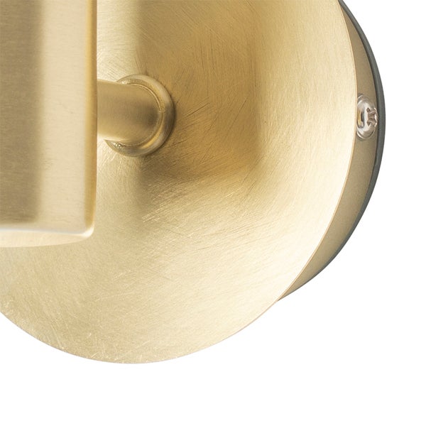 Detailansicht einer runden Wandhalterung aus gebürstetem Metall in Goldoptik mit sichtbarer Befestigungsschraube.