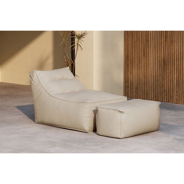 Moderner Sitzsack-Sessel mit passendem Hocker in Beige auf einer Terrasse mit Betonboden, Holzlamellenwand und einer Pflanze.
