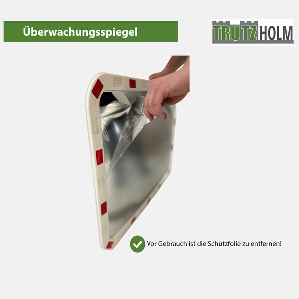 Trutzholm Überwachungsspiegel mit Hand beim Abziehen der Schutzfolie von der Spiegelfläche.