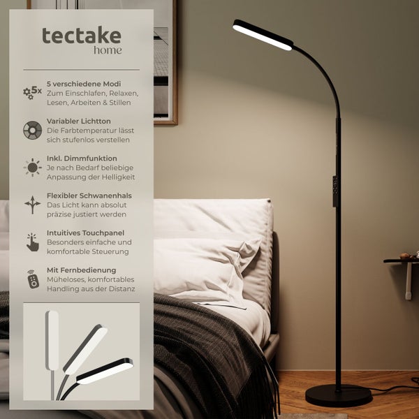 Schwarze Stehleuchte mit Schwanenhals und Touchpanel neben einem Bett im Schlafzimmer
