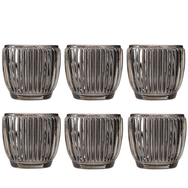 Sechs Teelichthalter aus geriffeltem Glas.