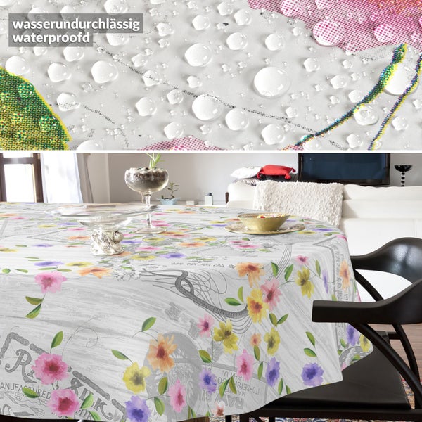 Rundes Tischtuch mit Blumenmuster im Wohnzimmer, wasserundurchlässiges Material mit Wassertropfen in der Detailansicht.