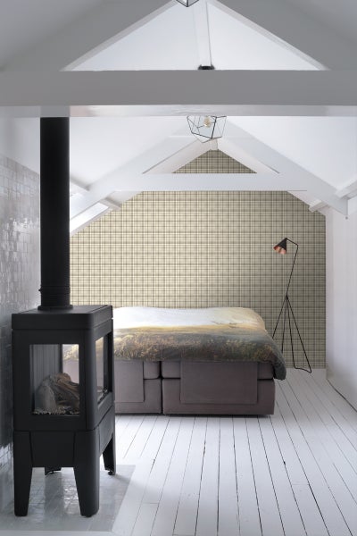 Schlafzimmer mit Kamin, Bett und karierter Tapete unter einem Dach