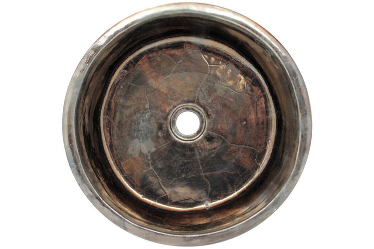 Aufsicht auf ein rundes Waschbecken mit Abflussloch