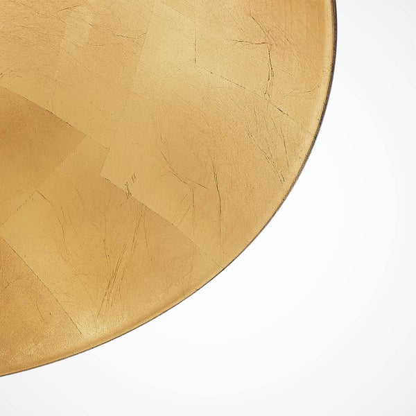 Detailansicht einer runden Tischplatte mit Blattgoldoberfläche