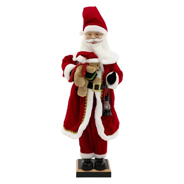 Dekorativer Weihnachtsmann mit Teddybär und Laterne als festliche Dekoration