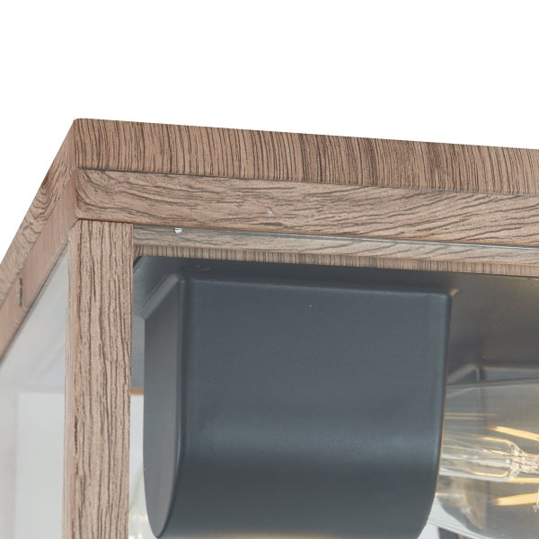 Detailansicht einer Leuchte mit Rahmen in Holzoptik und schwarzer Fassung.