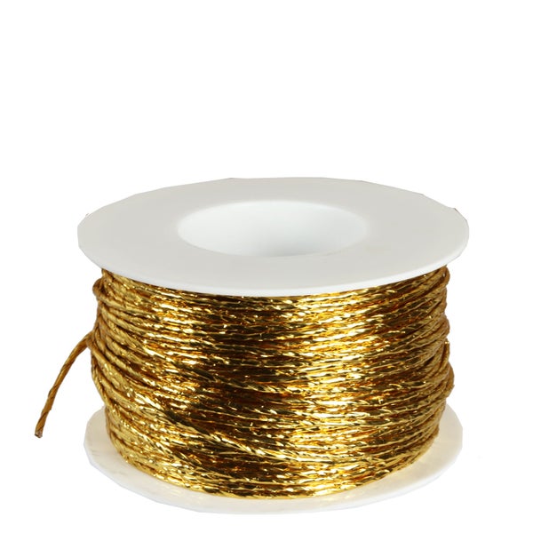Goldfarbene Dekokordel auf weißer Kunststoffspule.