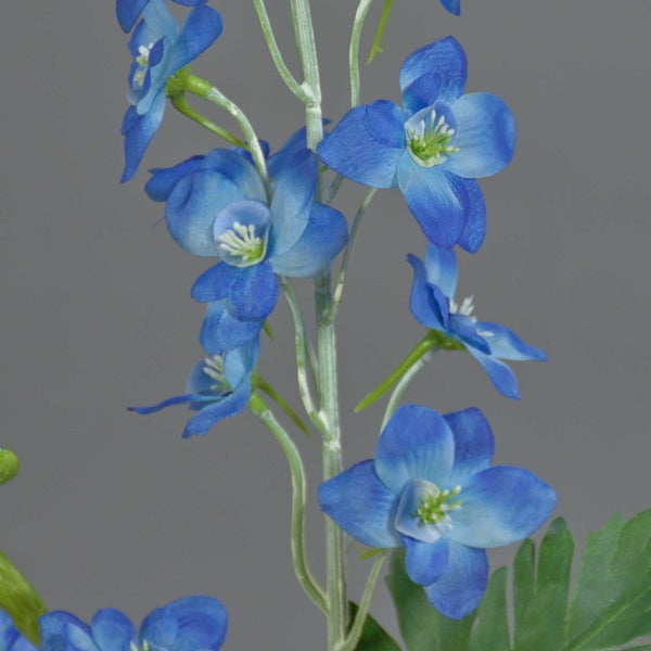 Künstlicher Rittersporn mit blauen Blüten aus Textil und grünem Stiel.