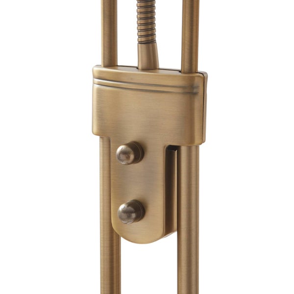 Detail eines Lampenschalters aus antikem Messing mit zwei Drehknöpfen und Metallgestänge.