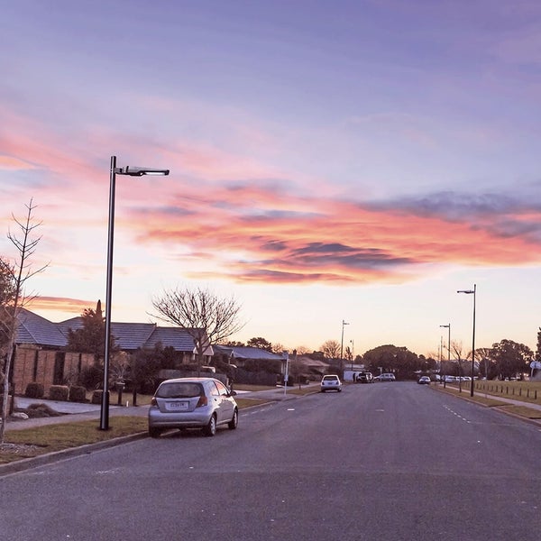 Szene einer Wohngegend mit Straßenlaternen bei Sonnenuntergang
