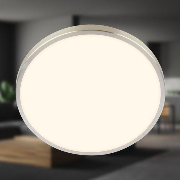 Runde LED-Deckenleuchte mit Metallrahmen in einem modern eingerichteten Raum.