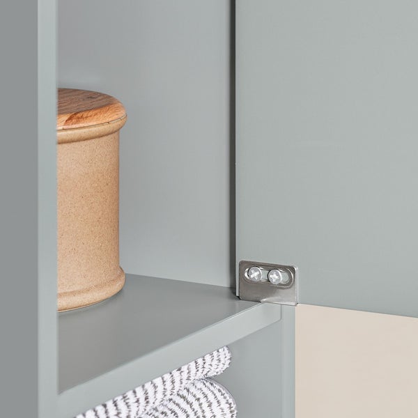 Detailansicht eines Badezimmerschranks mit Ablage, Handtüchern und Aufbewahrungsbehälter