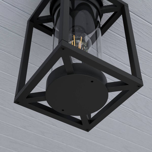 Moderne Außenwandleuchte mit schwarzem Metallrahmen, Glaszylinder und sichtbarem LED-Leuchtmittel im Filament-Stil an einer Hauswand.