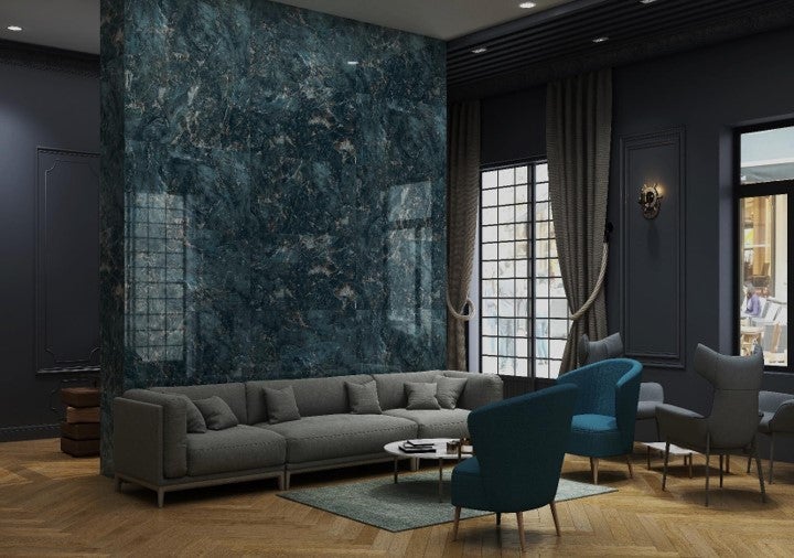 Modernes Wohnzimmer mit grauer Couch, Sessel und Wandfliesen in Marmoroptik