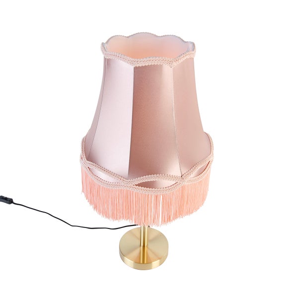 Klassische Tischleuchte mit rosafarbenem Stoffschirm, Fransen und goldenem Metallfuß.