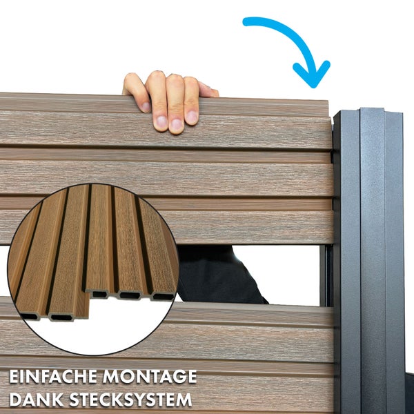 Holzzaun mit schwarzen Zaunpfosten vor einem Gebäude