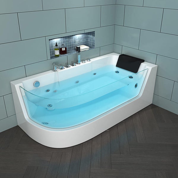 Moderne Whirlpool Badewanne mit integrierter Glasfront und Nackenkissen vor gefliesten Badwänden.