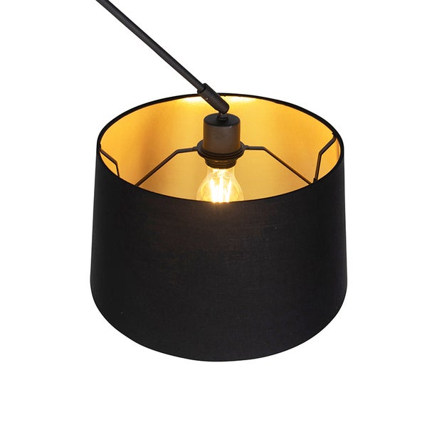 Lampenschirm aus schwarzem Textil mit goldfarbener Innenseite und leuchtendem Leuchtmittel.