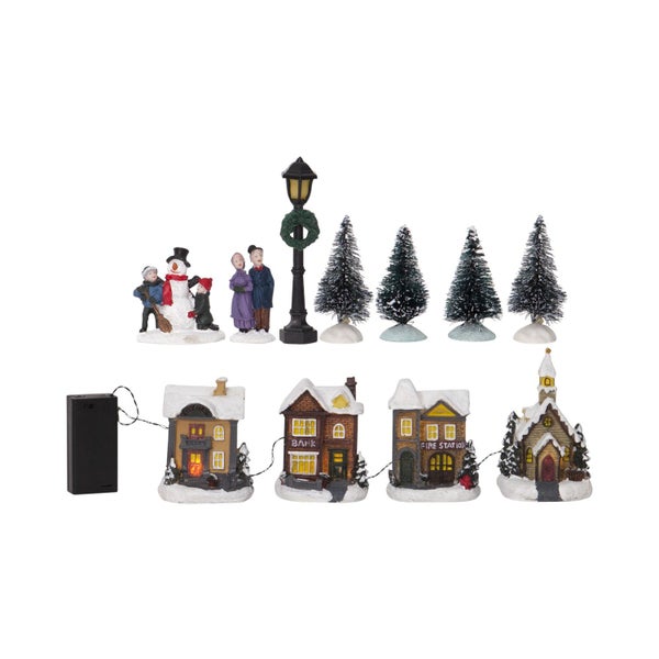 Weihnachtsdorf-Szene mit Figuren, Bäumen und beleuchteten Häusern