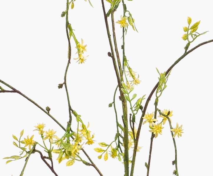 Künstlicher Zweig mit gelben sternförmigen Blüten und kleinen grünen Blättern.