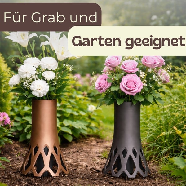 Zwei Grabvasen mit Blumen auf einem Gartenweg.