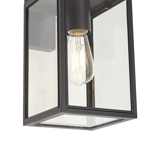 Außenwandleuchte im Laternen-Stil mit schwarzem Metallrahmen, Klarglas und leuchtendem LED-Leuchtmittel.