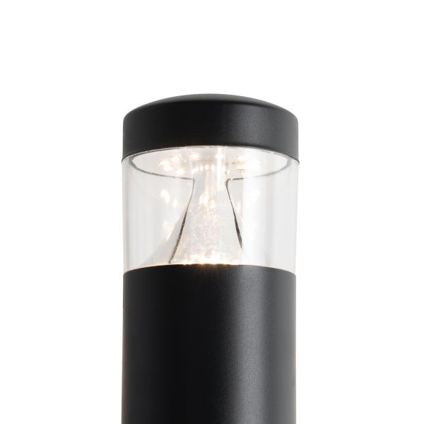 Oberer Teil einer schwarzen zylindrischen LED Außenleuchte mit transparentem Sichtfenster und eingeschaltetem Leuchtmittel.