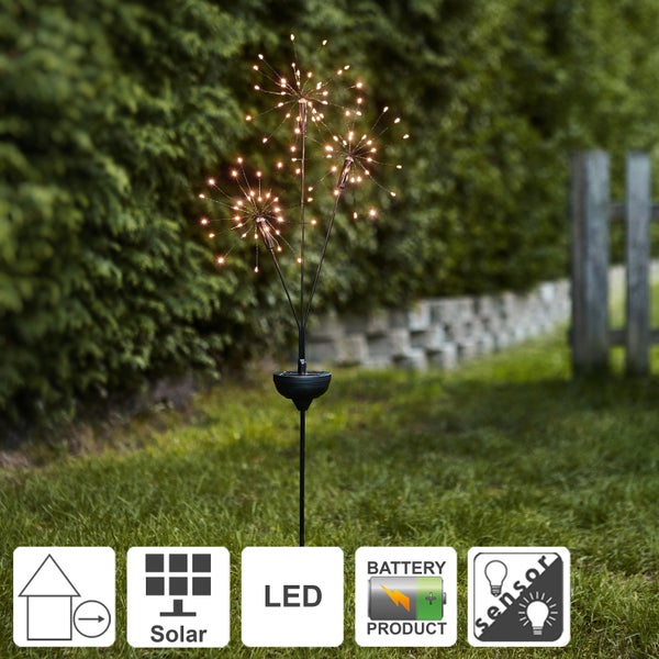 Solarleuchte in Feuerwerksoptik mit LED auf einer Rasenfläche