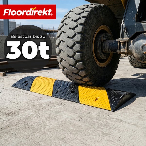 Floordirekt Logo. Eine schwarz-gelbe Fahrbahnschwelle wird von einem großen Reifen belastet. Belastbar bis zu 30 Tonnen.