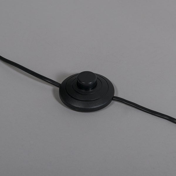 Schwarzer, runder Trittschalter für Lampen mit integriertem Stromkabel.