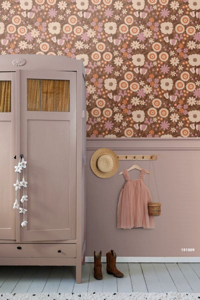 Vliestapete mit großflächigem Blumenmuster im Retro-Stil kombiniert mit passender Wandgestaltung und einem Holzschrank im Kinderzimmer.