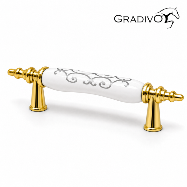 Möbelgriff von Gradivo aus Metall und Keramik, goldfarben mit weißem Griffstück und Ornamentmuster.