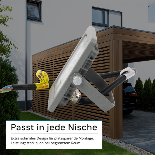 LED-Strahler zur Außenbeleuchtung mit Anschlusskabel vor Hauswand